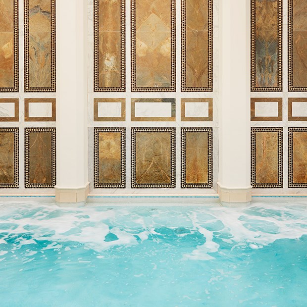 An elegant poolside wall design adds a beautiful touch to the surrounding environment.