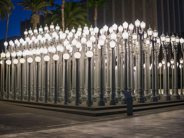 LACMA museum outside with rows of white lampposts at night