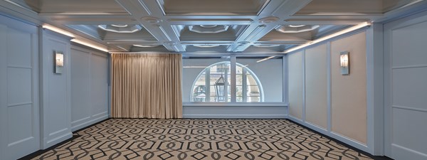 Beverly event space with blue walls, pattern carpet and wide windows
