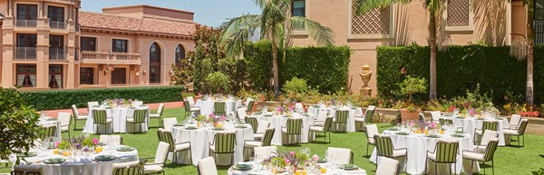 Chairs and round tables set up outside in the Garden Terrace for an event