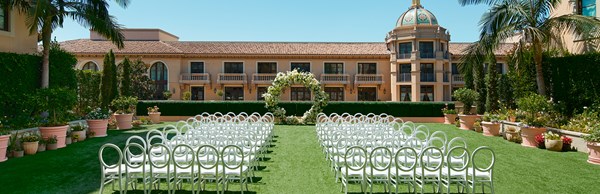 White chairs lined up either side of the aisle outside in the Garden Terrace