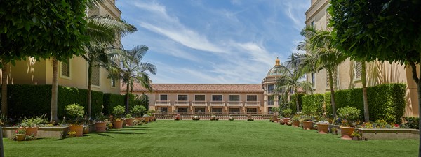 The Garden Terrace outside space with grass and palm trees