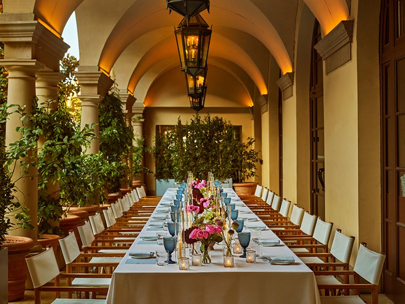 Long table set up for a private dining event with flowers and candles