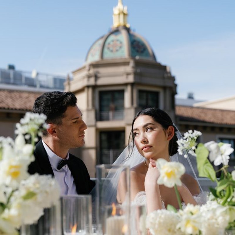 a bride and groom looking at eachother on their wedding day