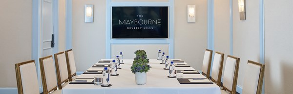 Wilshire room at Maybourne Beverly Hills set up as a corporate event with screen on the wall.