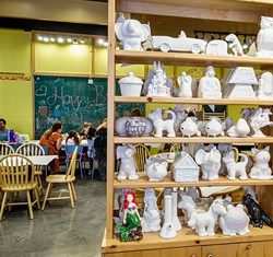 Shelves of pottery to be painted in pottery studio Colour Me Mine