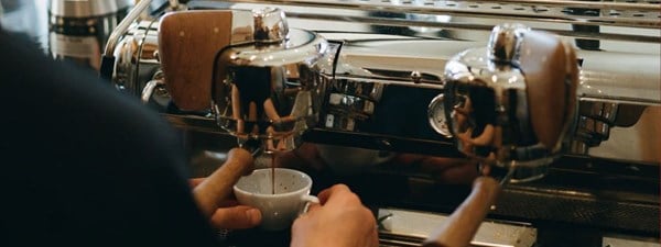 an espresso machine making a cup of coffee