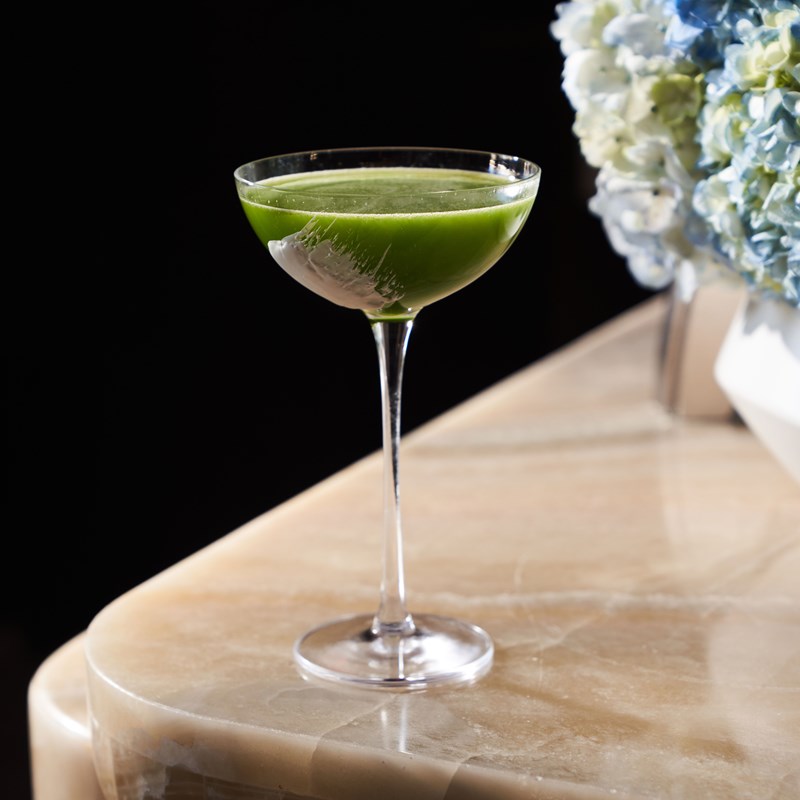 Green colored cocktail in a martini glass