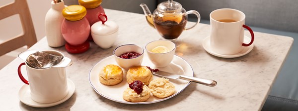 Tea and scones with jam on a table