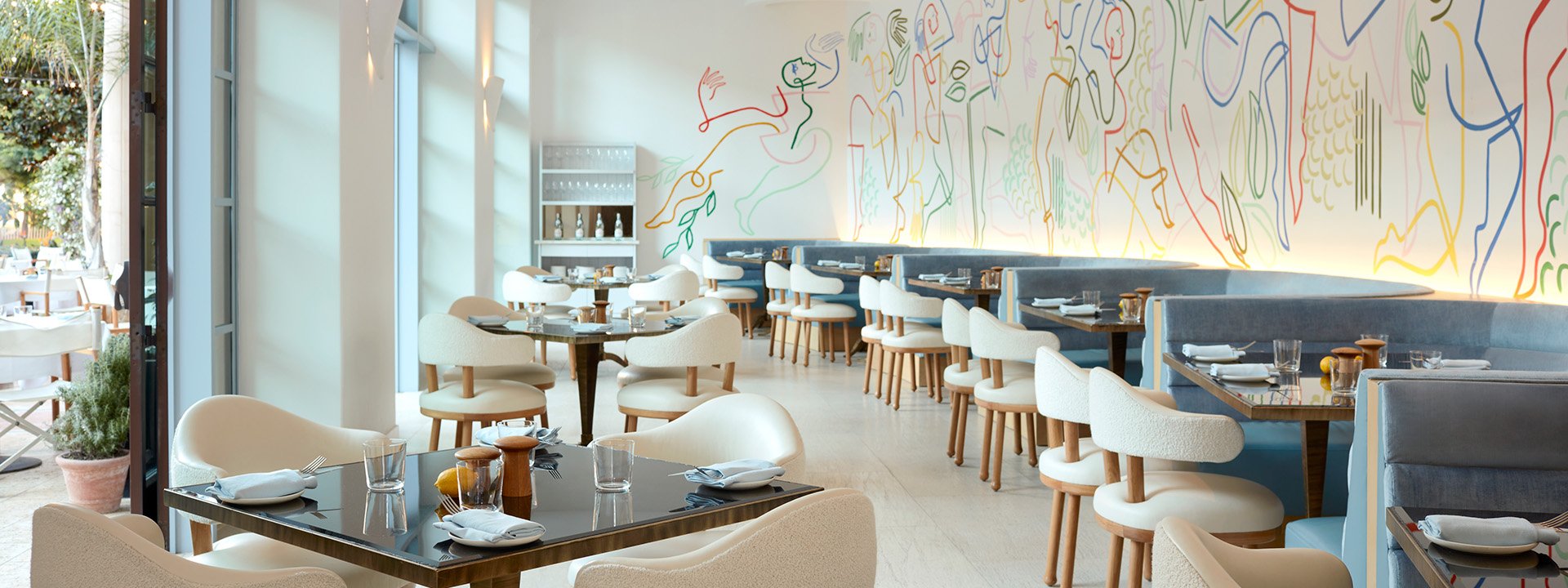 The restaurant's dining space showcases trendy decor with wall graffiti, enhancing its distinctive character.