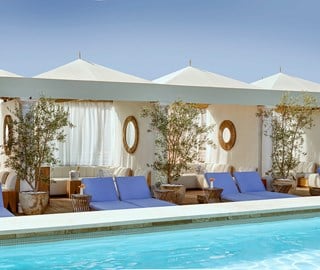 pool cabanas with blue lounge chairs