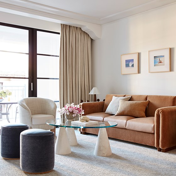 Neat living room, sofa set, window-side glass coffee table, creating an inviting ambiance.