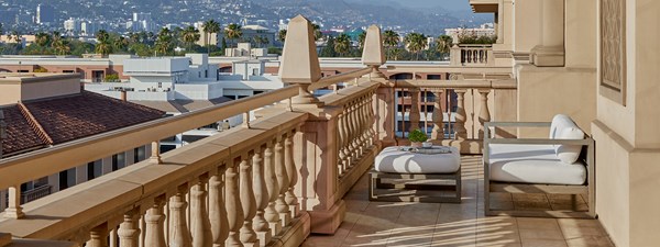 White cushioned lounge chair on terrace looking out to Hollywood skyline in The Residence