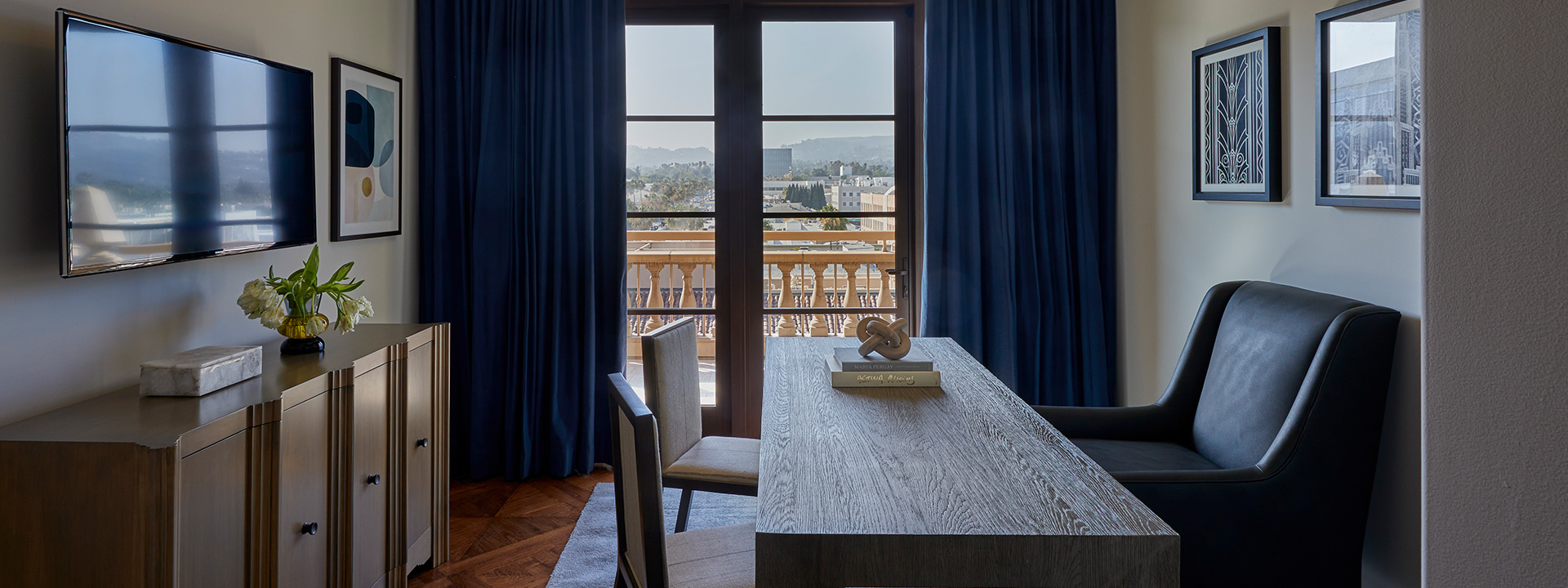 Wooden desk and chair in office looking out to the  L.A skyline in The Residence
