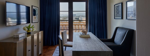 Wooden desk and chair in office looking out to the  L.A skyline in The Residence