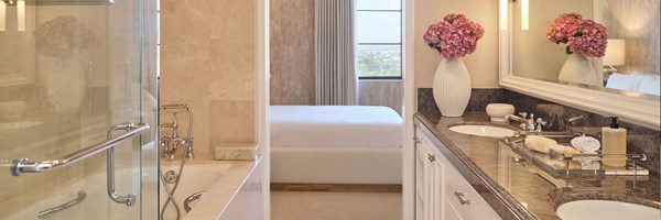 Marble bathroom of the Three-bedroom residence showing a vanity area and bath