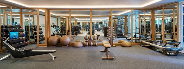 Fitness center with stretching area and various gym equipment