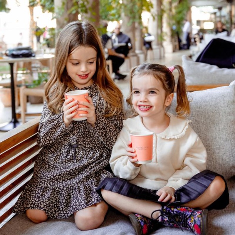 two young girls drinking hot chocolate