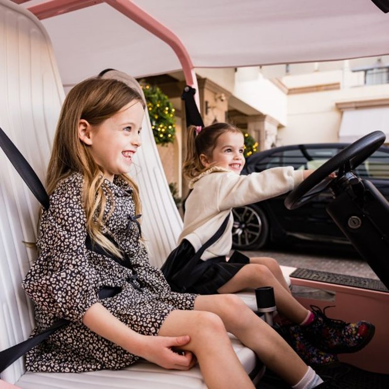 two young girls in a moke car