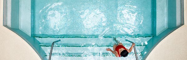 Mineral spa pool with a woman in a red swimsuit